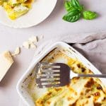 Homemade basil pesto is spread over fresh cannelloni pasta recipe and baked in a luscious cheesy provolone bechamel sauce and topped with mozzarella cheese, comfort food heaven! Insidetherustickitchen.com
