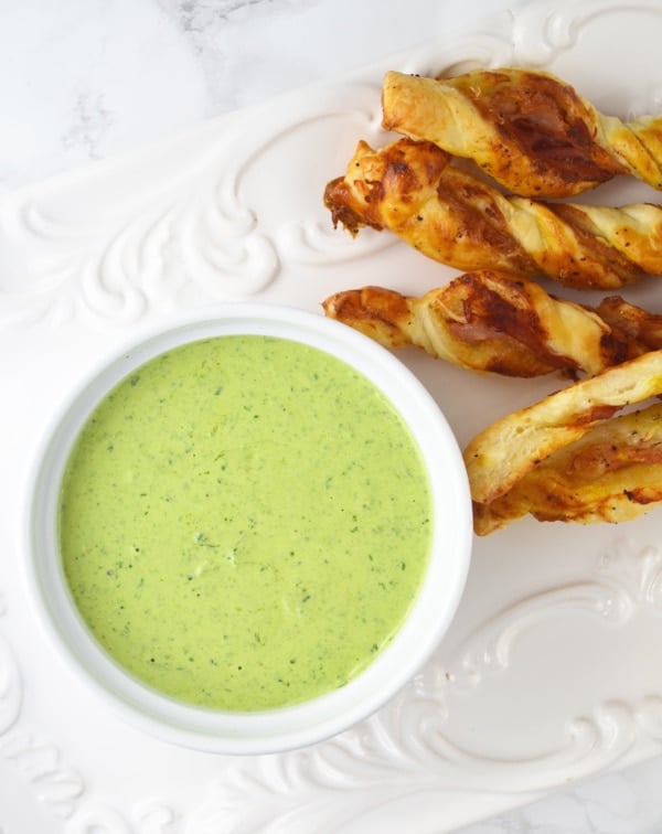 You will love this Sour Cream Pesto Dip with Prosciutto Dippers Recipe. Homemade pesto is swirled with sour cream and served with mustard, Parmesan and Prosciutto pastry twists. www.insidetherustickitchen.com