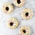 These Carrot Cake Doughnuts with Maple Frosting are baked to perfection with warming spices and topped with a delicious cream cheese maple frosting. www.insidetherustickitchen.com