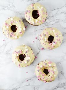 These Carrot Cake Doughnuts with Maple Frosting are baked to perfection with warming spices and topped with a delicious cream cheese maple frosting. www.insidetherustickitchen.com