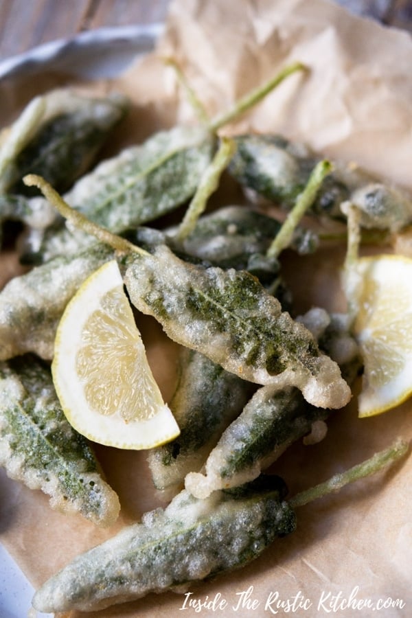Crispy Fried Sage Leaves with Anchovies. Fragrant sage leaves sandwiched together with anchovy fillets and dipped in a super simple batter. They're the perfect mix of crispy, savoury and salty and make a simple yet elegant Italian appetizer or snack that goes perfectly with a cocktail or glass of bubbly. | Italian Recipes | Italian Food | #Insidetherustickitchen #sage #Italian #Italianfood