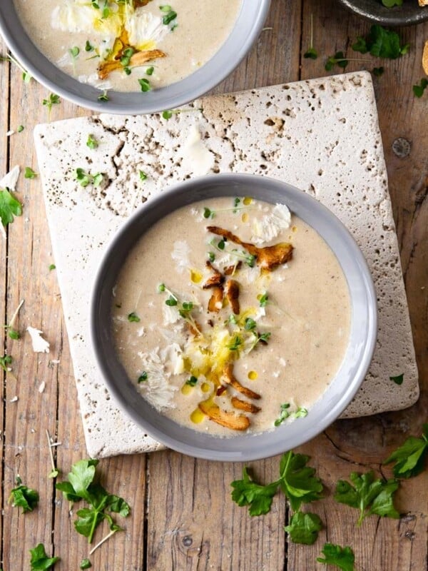 An overhead shot of creamy mushroom soup in two bowls