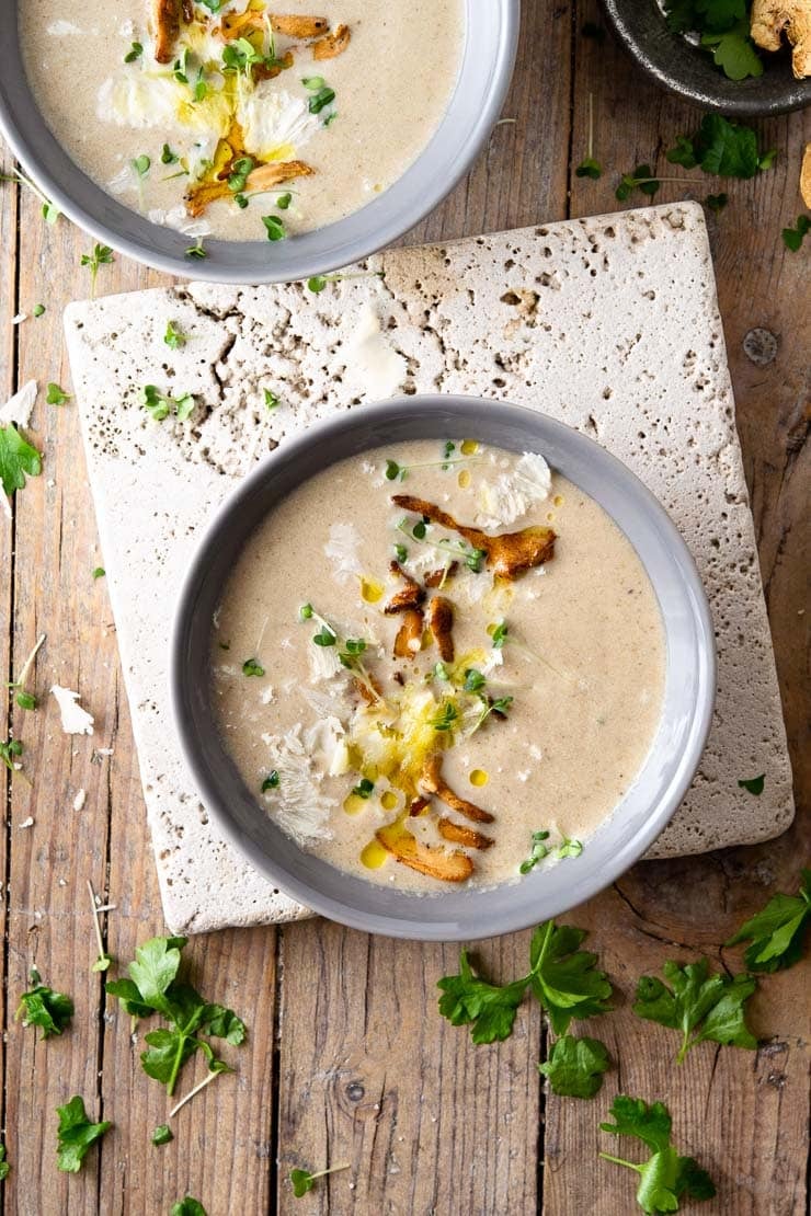 An overhead shot of creamy mushroom soup in two bowls