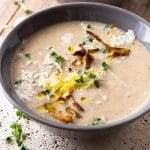 A close up of a bowl of creamy mushroom soup