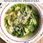 An overhead shot of a green spring vegetable soup in a vintage patterned bowl. The text overlay reads: spring vegetable soup - Minestrone Primavera.