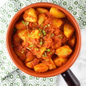 Patate Rifatte (redone potatoes) are a great potato side dish made from leftover boiled potatoes, fried with garlic and herbs and cooked in a delicious tomato sauce. www.insidetherustickitchen.com