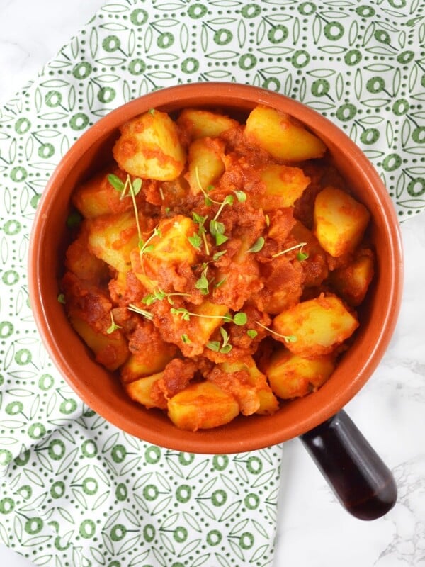 Patate Rifatte (redone potatoes) are a great potato side dish made from leftover boiled potatoes, fried with garlic and herbs and cooked in a delicious tomato sauce. www.insidetherustickitchen.com