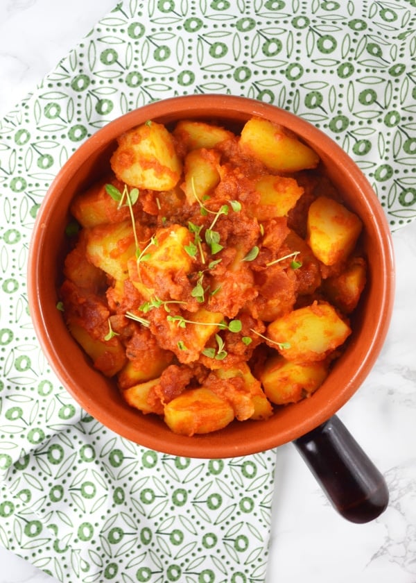 Patate Rifatte (redone potatoes) are a great potato side dish made from leftover boiled potatoes, fried with garlic and herbs and cooked in a delicious tomato sauce. www.insidetherustickitchen.com