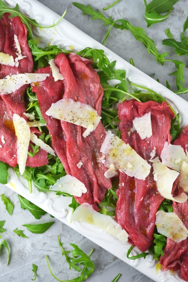 Beef Carpaccio is a classic Italian salad made with beef fillet, arugula, parmesan, lemon and olive oil. www.insidetherustickitchen.com