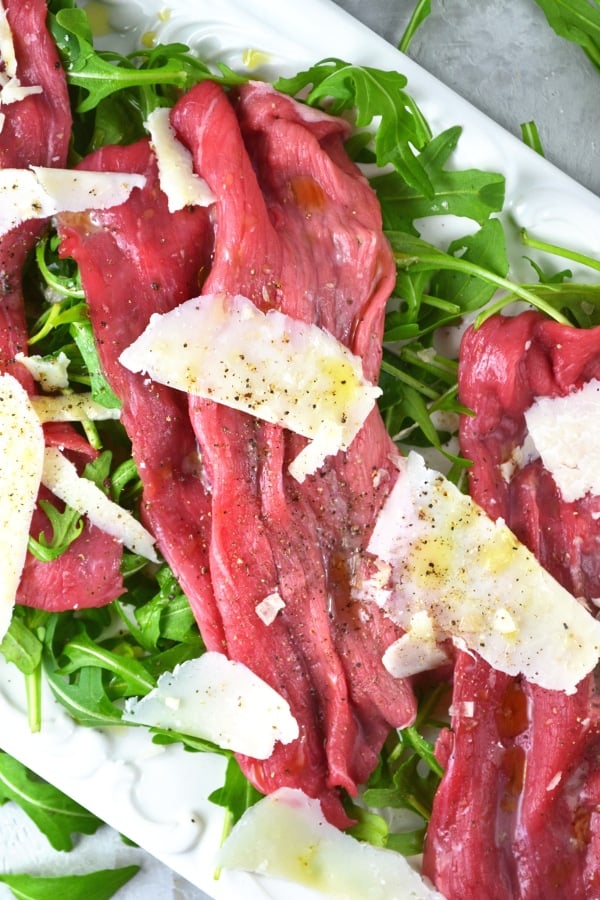 Beef Carpaccio is a classic Italian salad made with beef fillet, arugula, parmesan, lemon and olive oil. www.insidetherustickitchen.com