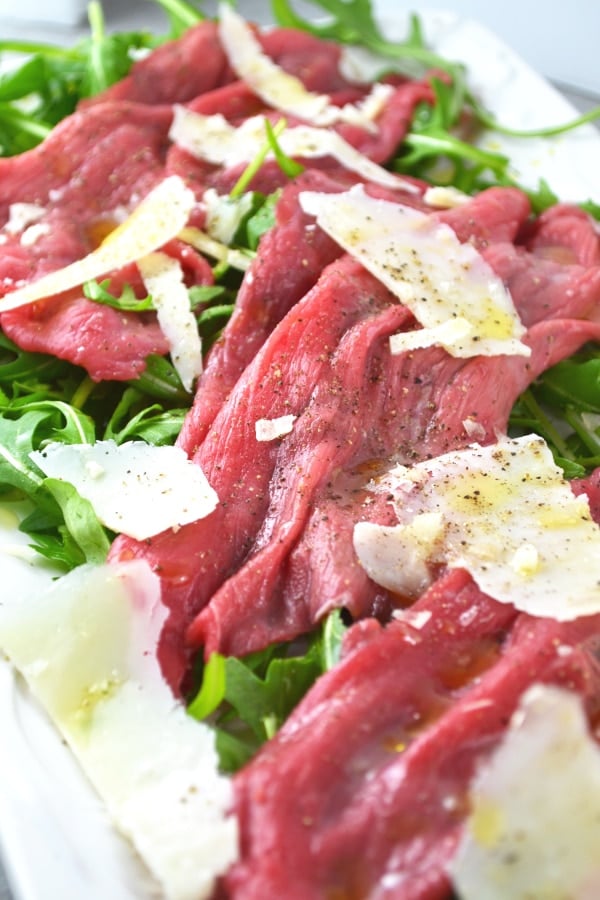 Beef Carpaccio is a classic Italian salad made with beef fillet, arugula, parmesan, lemon and olive oil. www.insidetherustickitchen.com