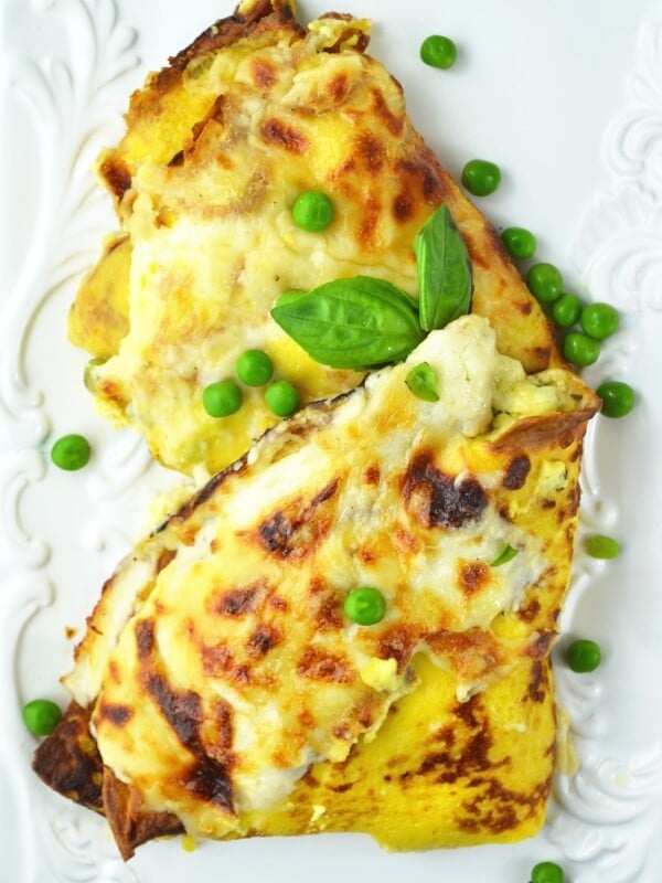 These Crespelle (savoury crepes) are stuffed with ricotta, peas and ham and baked with a delicious Fontina cheese sauce! www.insidetherustickitchen.com