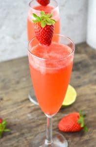 These delicious strawberry bellini are a refreshing Prosecco cocktail made with fresh strawberries and zesty lime juice www.insidetherustickitchen.com