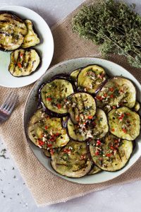 Easy Italian marinated eggplant recipe- grilled eggplant/aubergine marinated in garlic, oregano, chili and mint. Perfect as a side, with salad or as an antipasto with drinks. So easy, you'll love it, inside the rustic kitchen.