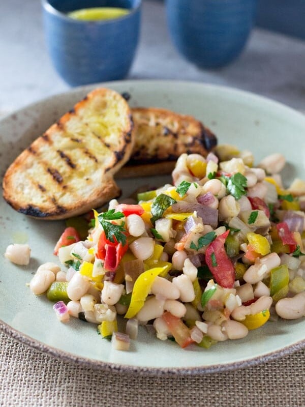A warm easy bean salad recipe with yellow pepper, eggplant, tomatoes, garlic and delicious fresh herbs. This makes a perfect easy, simple and delicoius dinner or lunch alongside some char grilled crusty bread. insidetherustickitchen.com