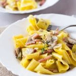 A delicious speck and mushroom pappardelle pasta made with a simple and incredibly delicious creamy sauce. www.insidetherustickitchen.com