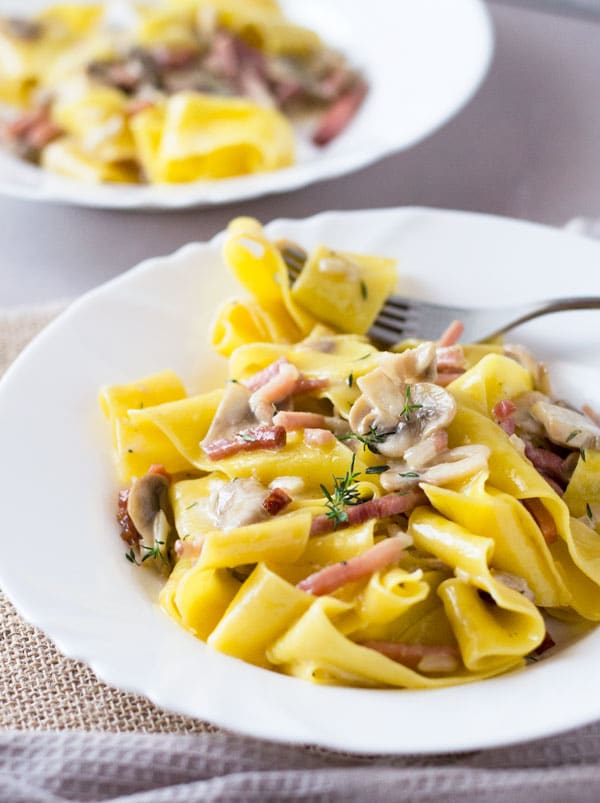 A delicious speck and mushroom pappardelle pasta made with a simple and incredibly delicious creamy sauce. www.insidetherustickitchen.com