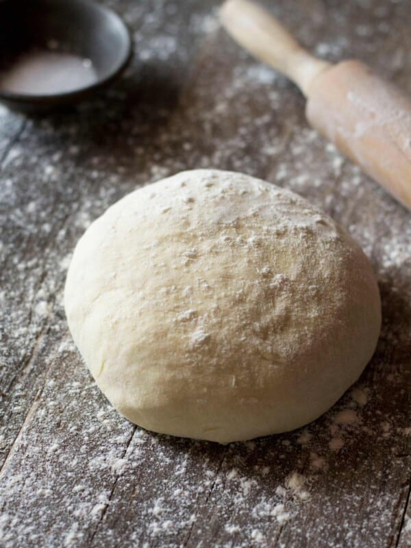 A ball of yeast free pizza dough on a wooden work surface