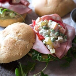 A close up of Russian salad on a roll