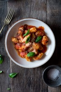 Light and soft gnocchi with tomato sauce recipe made with ripe, fresh tomatoes, oregano and garlic. Extremely simple and easy to make, a great authentic Italian tomato sauce recipe that's great with pasta and gnocchi. For more authentic Italian recipes visit Inside The Rustic Kitchen