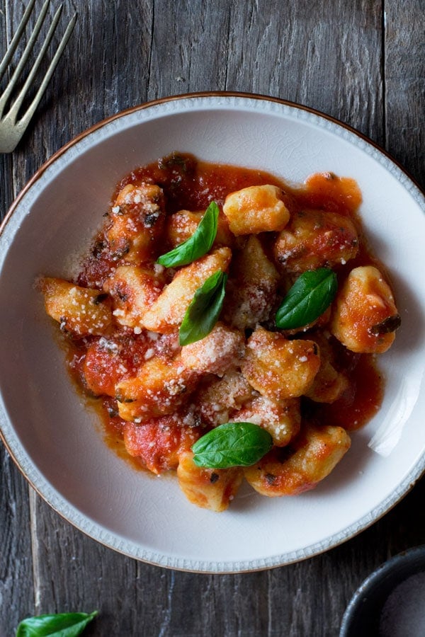 Gnocchi with fresh tomato sauce inside the rustic kitchen