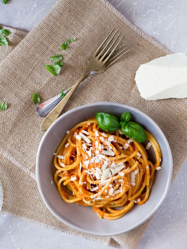 Bucatini pasta with a roasted red pepper cream sauce recipe topped with shavings of ricotta salata. A super easy pasta recipe for weeknights. inside the rustic kitchen
