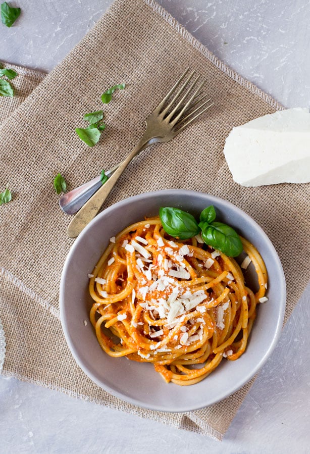 Bucatini pasta with a roasted red pepper cream sauce recipe topped with shavings of ricotta salata. A super easy pasta recipe for weeknights. inside the rustic kitchen