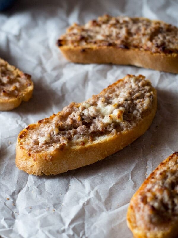 This two ingredient stracchino and sausage crostini is so simple and crazy delicious. Tangy, soft cheese is mixed with Italian sausage and spread on some thick crusty bread. An easy sausage crostini recipe you're sure to love. More authentic italian recipes at Insidetherustickitchen.com