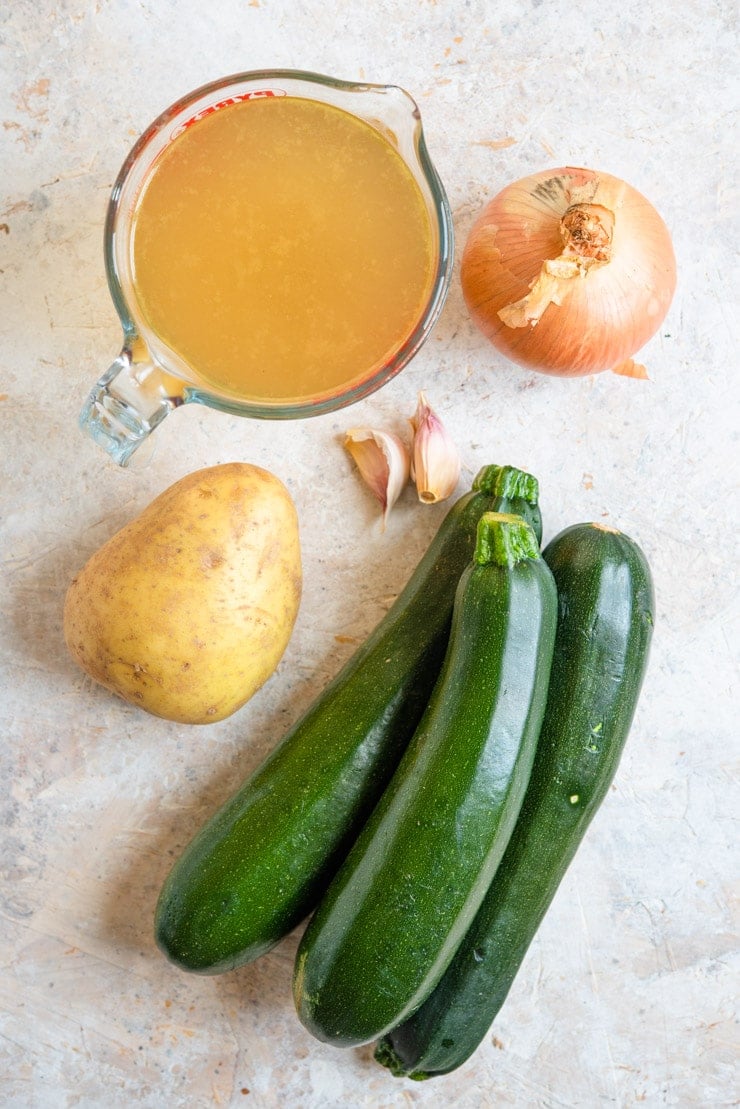 An overhead shot of ingredients used to make creamy zucchini soup