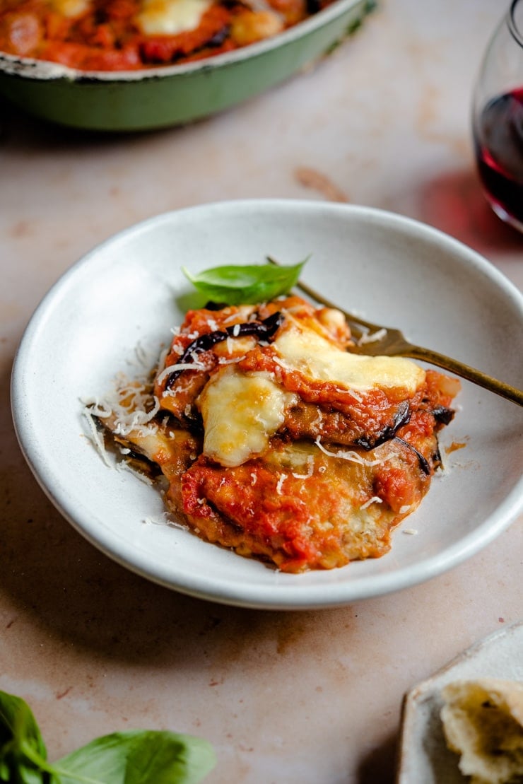 Eggplant parmigiana in a bowl with a fork