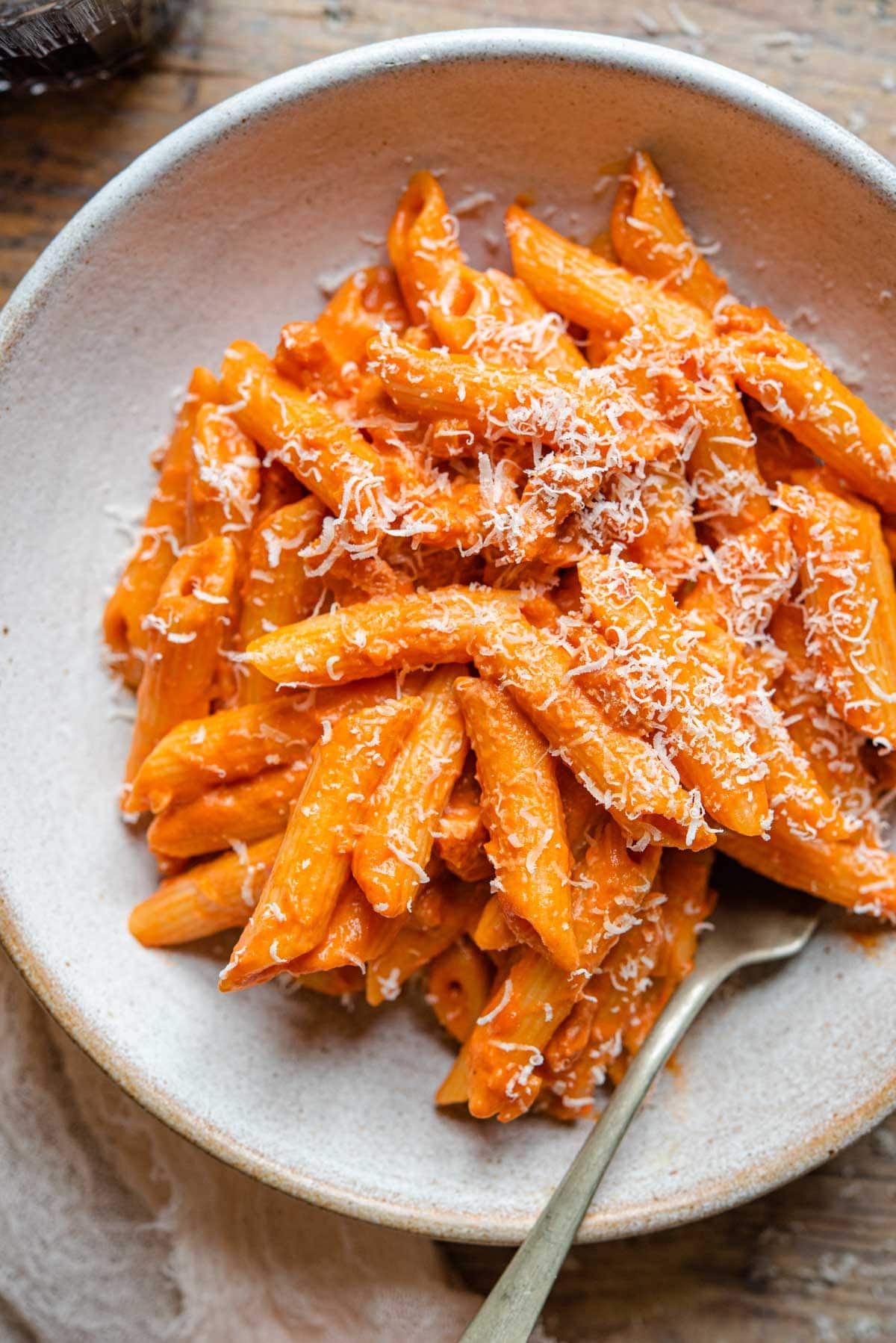 A close of penne alla vodka in a rustic bowl