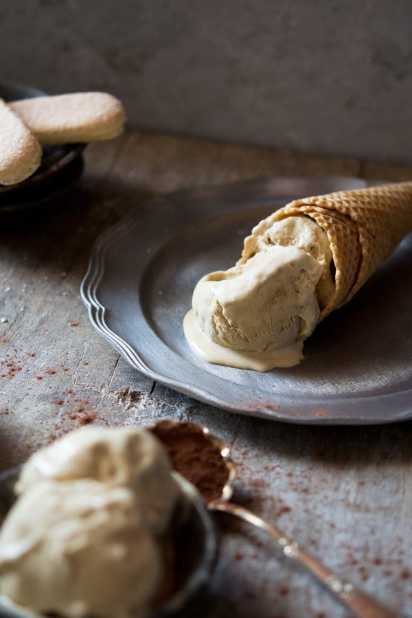 Ice cream melting on an ice cream cone sitting on a plate