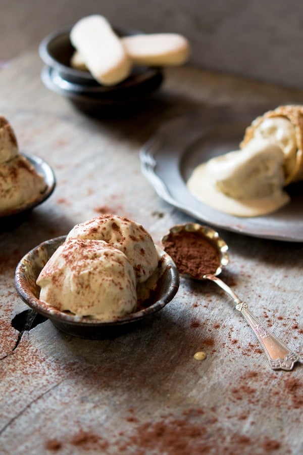 Two scoops of ice cream in a small  rustic bowl