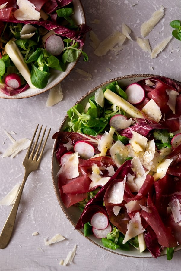 Bresaola salad with apple and radicchio. An easy Italian salad recipe with parmesan, radishes and a simple garlic, olive oil dressing. A great light lunch or starter that's packed full of delicious flavours. More authentic Italian recipes at Inside the rustic kitchen.