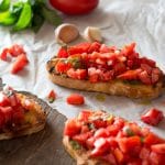 Bruschetta al pomodoro - classic Italian tomato bruschetta recipe made with ripe, juicy tomatoes, fresh basil and extra virgin olive oil. Served on char grilled, garlic toasts, this one is always a winner! Inside the rustic kitchen