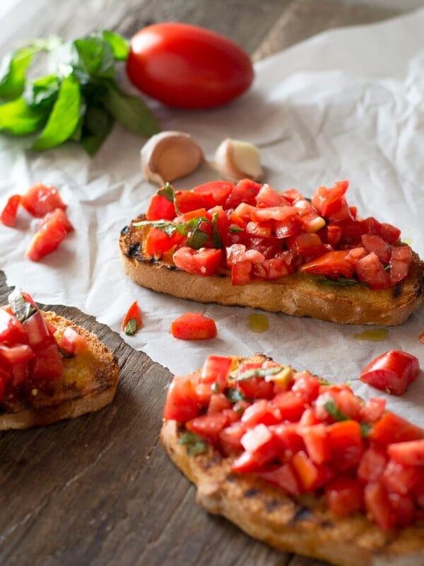 Bruschetta al pomodoro - classic Italian tomato bruschetta recipe made with ripe, juicy tomatoes, fresh basil and extra virgin olive oil. Served on char grilled, garlic toasts, this one is always a winner! Inside the rustic kitchen