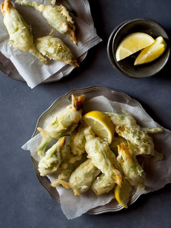 Crispy, deep fried ricotta stuffed zucchini flowers with lemon and chili flakes. An easy, elegant and fun Italian appetizer that's hard to resist. How to fry zucchini flowers and recipe at Inside the rustic kitchen - authentic Italian recipes.