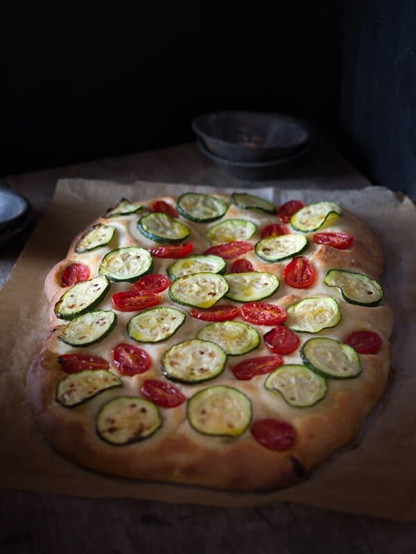 Delicious zucchini tomato focaccia. A simple Italian snack or appetizer with a crispy crust and soft, light and fluffy middle. Authentic Italian recipes and traditional Italian recipes at Inside the rustic kitchen.