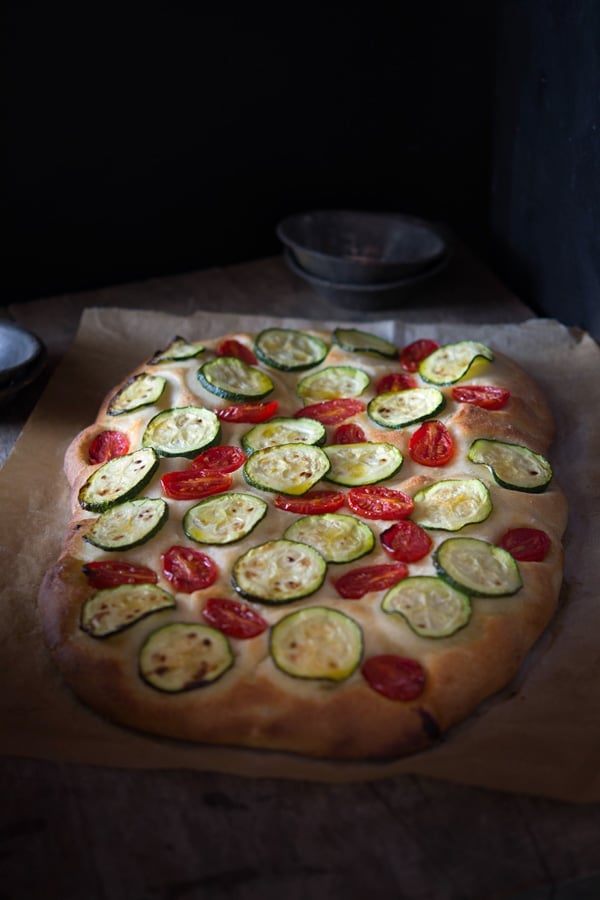 Delicious zucchini tomato focaccia. A simple Italian snack or appetizer with a crispy crust and soft, light and fluffy middle. Authentic Italian recipes and traditional Italian recipes at Inside the rustic kitchen.