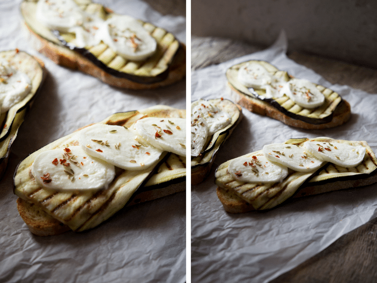 A close up photo of grilled eggplant on crusty bread with mozzarella. Eggplant bruschetta with mozzarella
