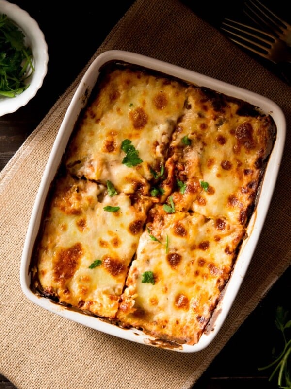 Lentil ragu lasagne in a baking dish cut into four