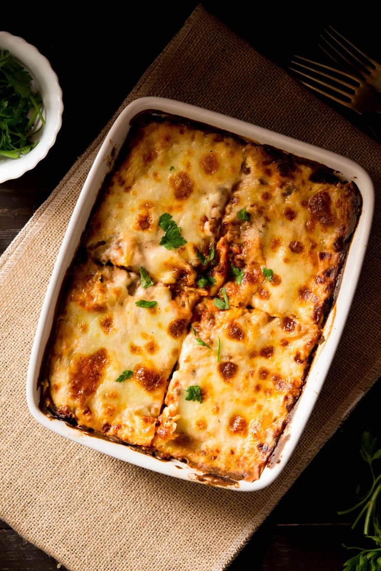 Lentil ragu lasagne in a baking dish cut into four