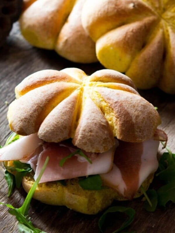A close up of a bread roll shaped like a pumpkin