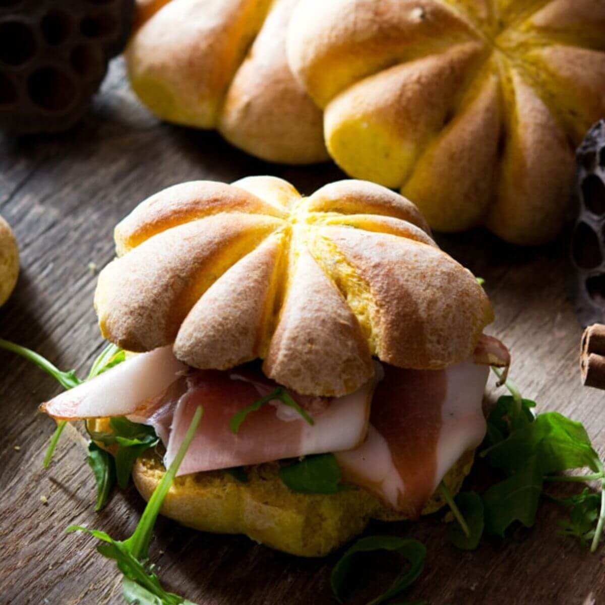 A close up of a bread roll shaped like a pumpkin