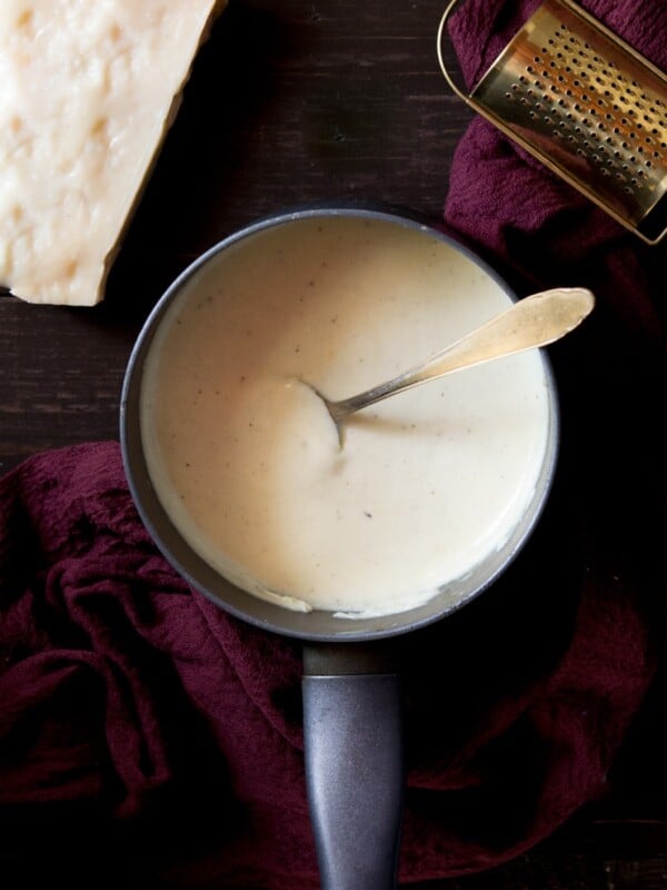 overhead shot of white sauce in a saucepan. How to make bechamel sauce recipe