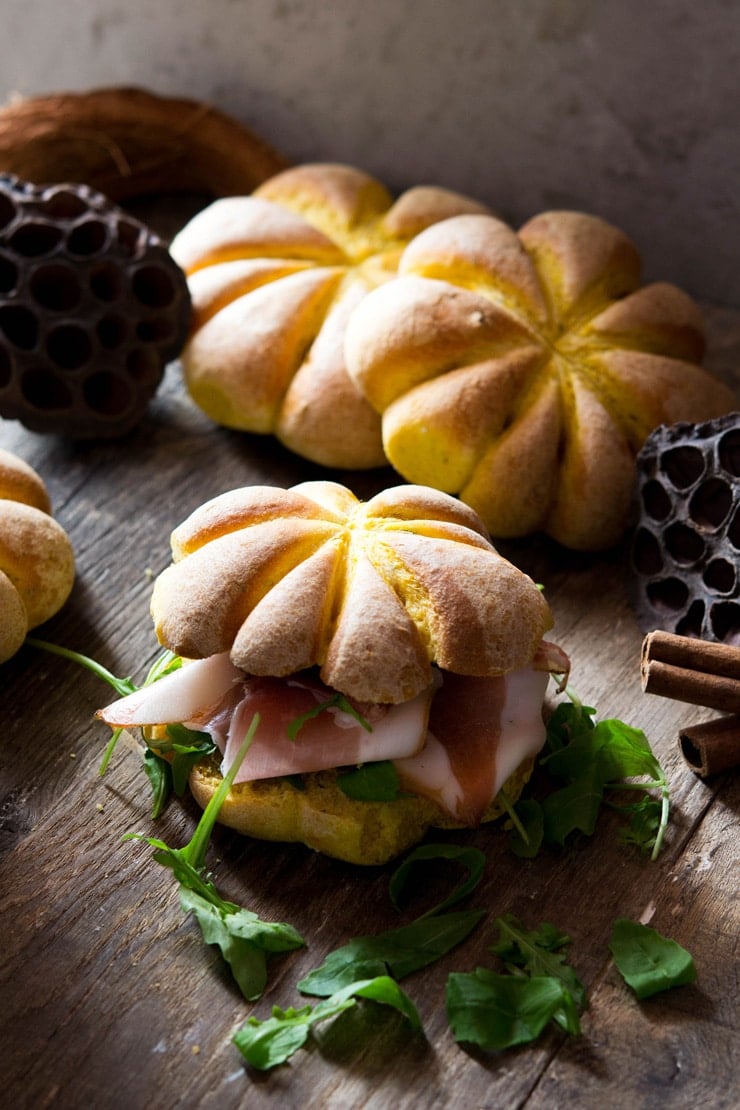 pumpkin bread rolls filled with prosciutto and arugula more pumpkin shaped rolls in the background