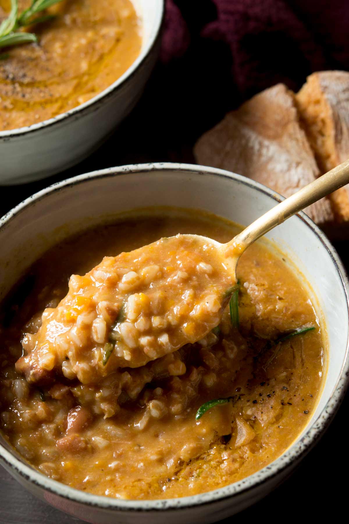 A close up of a spoonful of farro soup
