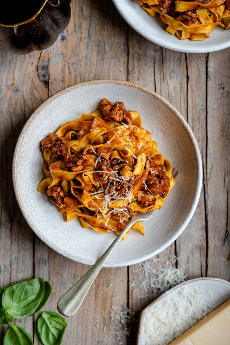 An overhead shot of Italian beef ragu in a rustic bowl