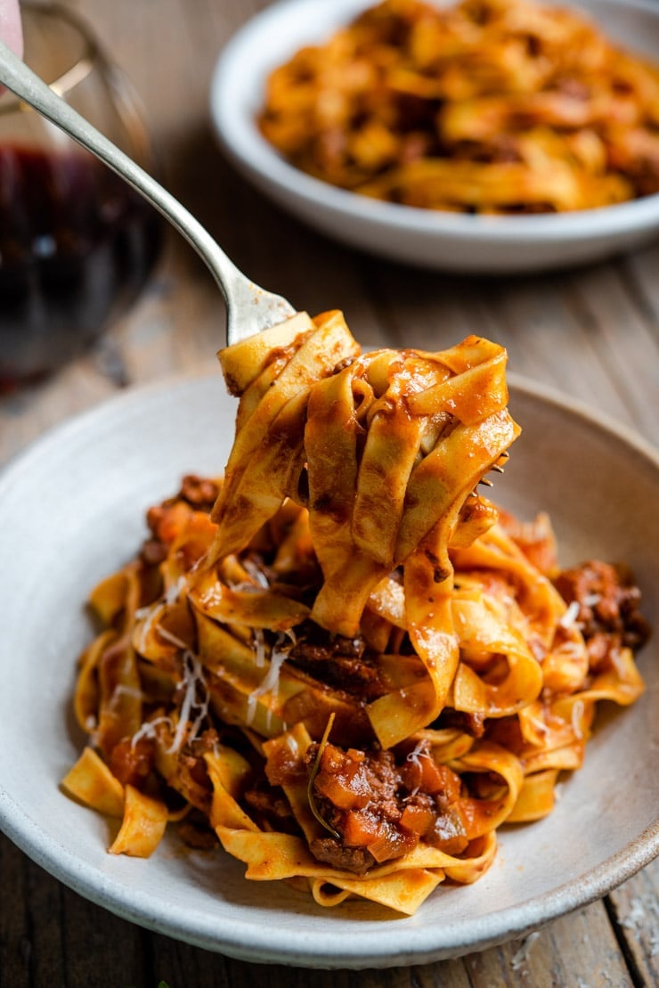 A close up of Italian beef ragu and pasta on a fork