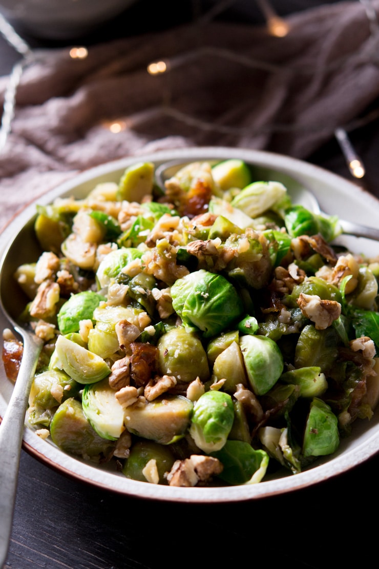 A close up of sauteed brussels sprouts with dates and walnuts